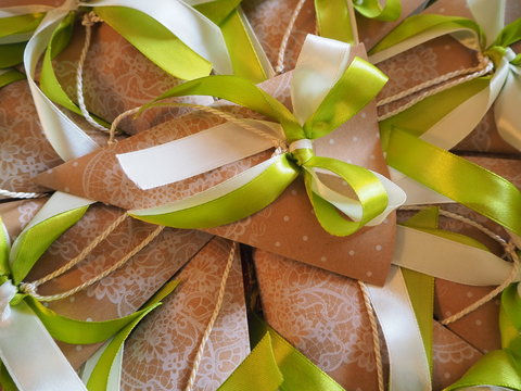 Handmade paper favors with green and white bow