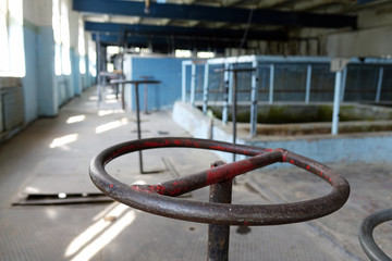 The old sewage treatment plant. Old and damaged sewage treatment plant devastated. Rusty valves.