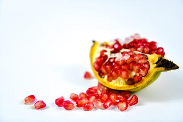Pomegranate fruit with seeds on white background