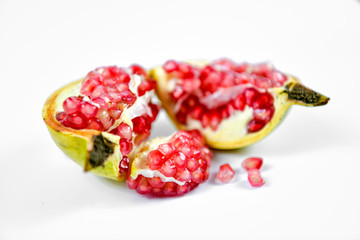 Pomegranate fruit with seeds on white background