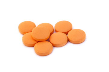 Orange pills isolated on white background