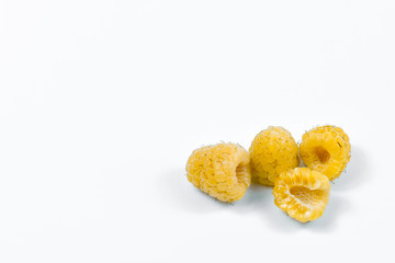 Set of yellow raspberry berry fruits on white background.