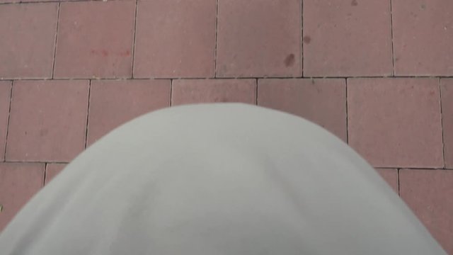 Top view belly of pregnant woman walks POV