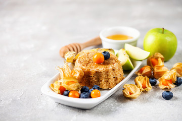 Fototapeta na wymiar Oat cake with honey and berries