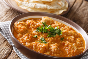 The chicken changezi of slow cooking complete with rich ingredients cream, cashew nuts, ghee, and the likes close-up on a plate. horizontal