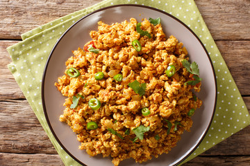 Indian dish Chicken Keema, with onions, tomatoes, spices and minced meat closeup. horizontal top view