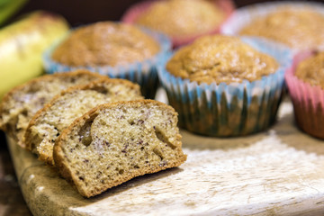 Banana Cupcake slided on a wooden cutting board.