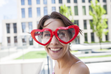 Fototapeta na wymiar Girl with glasses in the shape of heart.