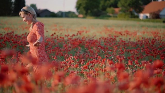 Mother and son running in a field of poppies in Denmark