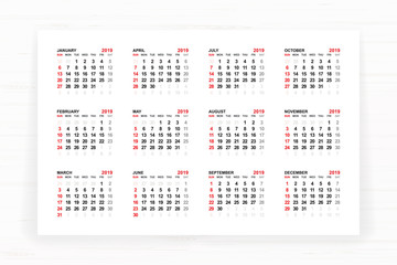 Calendar 2019 year on white paper with wooden texture background. Vector.