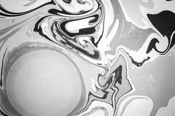 Abstract monochrome marble background. Stains of paint on the water. Ebru art, marbled paper.