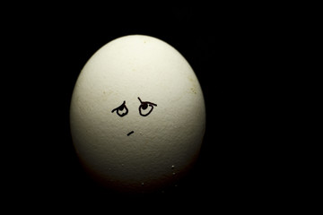 Egg represents human face isolated against black background