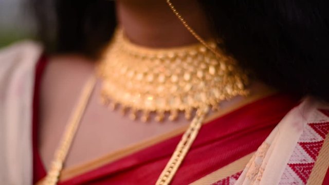 Close up shot of Indian gold jewellery on a married Indian woman