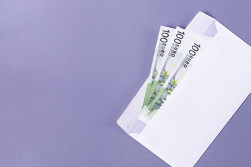 EURO notes in an envelope on a blue background - financial soncept.