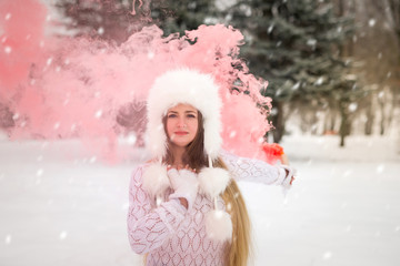 Portrait of beautiful woman with red smoke around