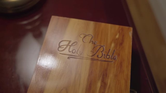 Open box containing a white bible and a photo of Jesus Christ