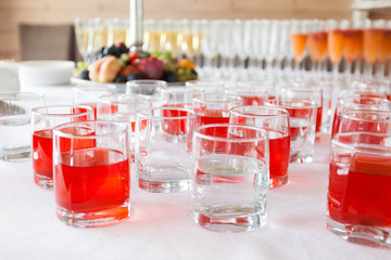 glassfuls with red and colorless drinks on the corporate event