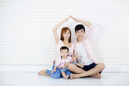 Happy Family  Making New House With Roof  By Hands