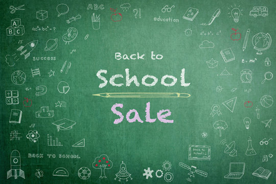 Back to school sale advertisement on school teacher’s green chalkboard background with copy space encircled by freehand students’ doodle for education announcement