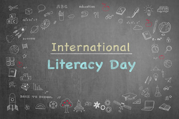 International literacy day on black chalkboard with doodle