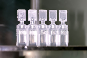five ml of a container with a medical preparation, a background image