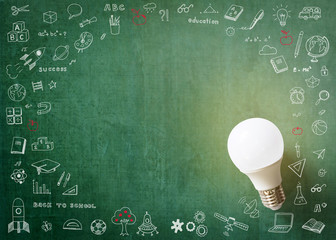 Innovative creative idea concept with LED lightbulb and school doodle on green school’s teacher or business chalkboard background with copy space