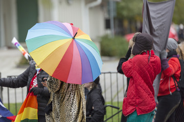 Person Carrying Rainbow Umbrella in Pride Parade
