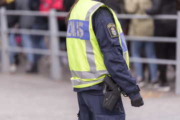 Swedish Police Officer with Reflective Vest and Gun