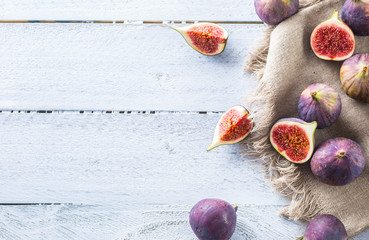 A few figs freely lying on old wooden table