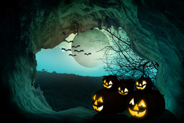 Halloween background. Spooky pumpkin with moon and dead trees on dark forest. Halloween design concept with copy space.