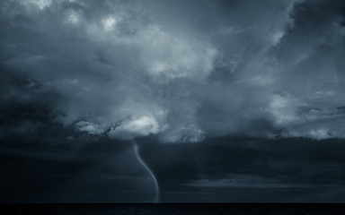 Ominous waterspout in a stormy sky. - obrazy, fototapety, plakaty