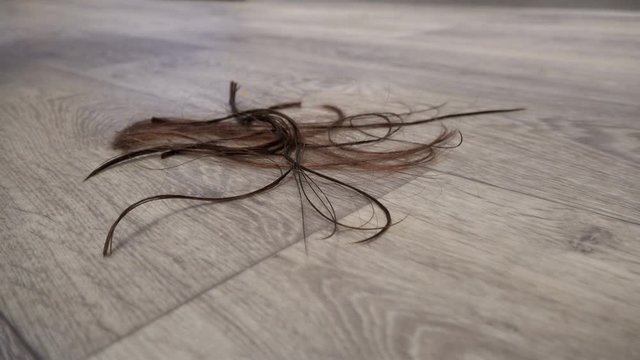 Trimmed hair falling on the floor. Fashion concept
