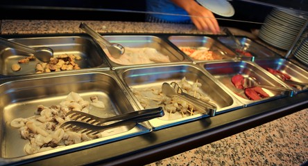 tray with raw foods like shrimp in Asian restaurant