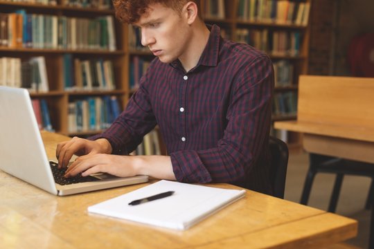 College student using laptop in library