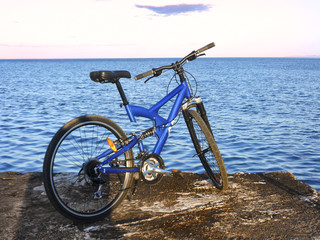 Mtb bike at the end of pier at sunset 