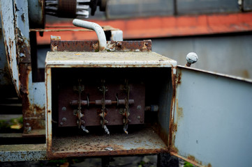 Fototapeta na wymiar Old rusty electric shield in an abandoned building. Retro