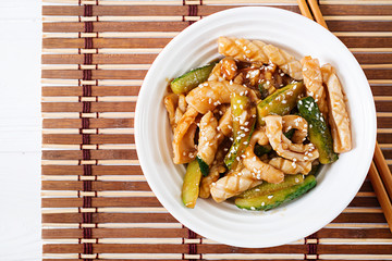 Thai spicy salad with squid and cucumber in sweet and sour sauce. Asian food. Top view.