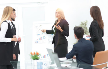 business woman doing a presentation to his business team.