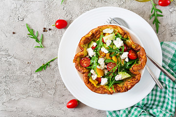 Omelet with fresh tomatoes, avocado and mozzarella cheese. Omelette salad. Breakfast. Healthy food. Top view. Flat lay