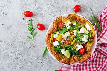 Omelet with fresh tomatoes, avocado and mozzarella cheese. Omelette salad. Breakfast. Healthy food. Top view. Flat lay