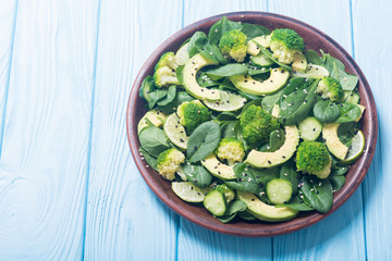 Green baby spinach salad with avocado