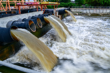 Large water pipe pump flood water and drain, captured with a slow shutter speed.
