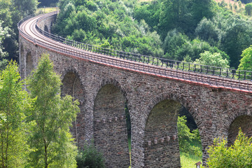Fototapeta na wymiar Old stone bridge railway lines over the valley in the Czech republic