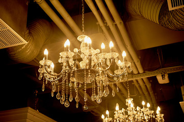 Several crystal chandeliers under the ceiling. Luxury and brilliance