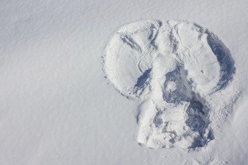 An outline of an angel in the snow.