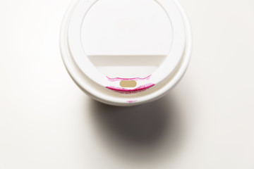 Cup of coffee with red lipstick.