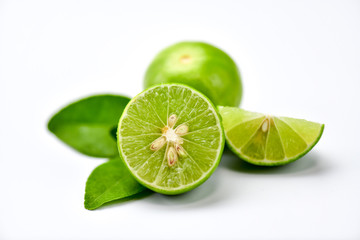 Lime fruit sliced and placed on white table.