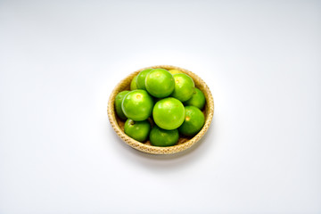 Fresh harvested limes in basket.