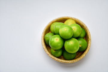Fresh harvested limes in basket.