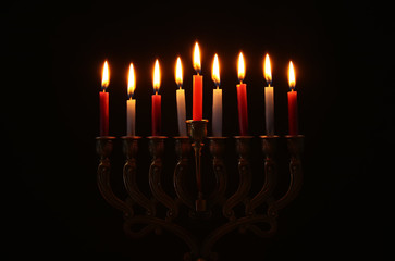 Image of jewish holiday Hanukkah background with menorah (traditional candelabra) and burning...